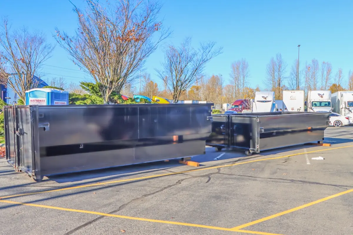 Professional dumpster rental service with roll-off container on residential driveway in Sawmills